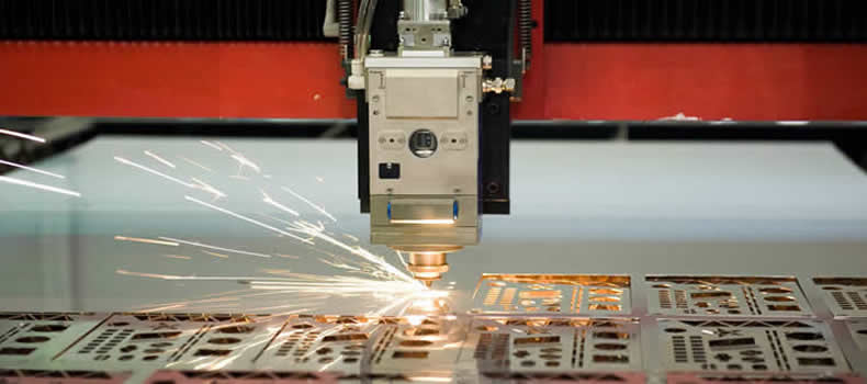 a machine laser cutting into a piece of metal